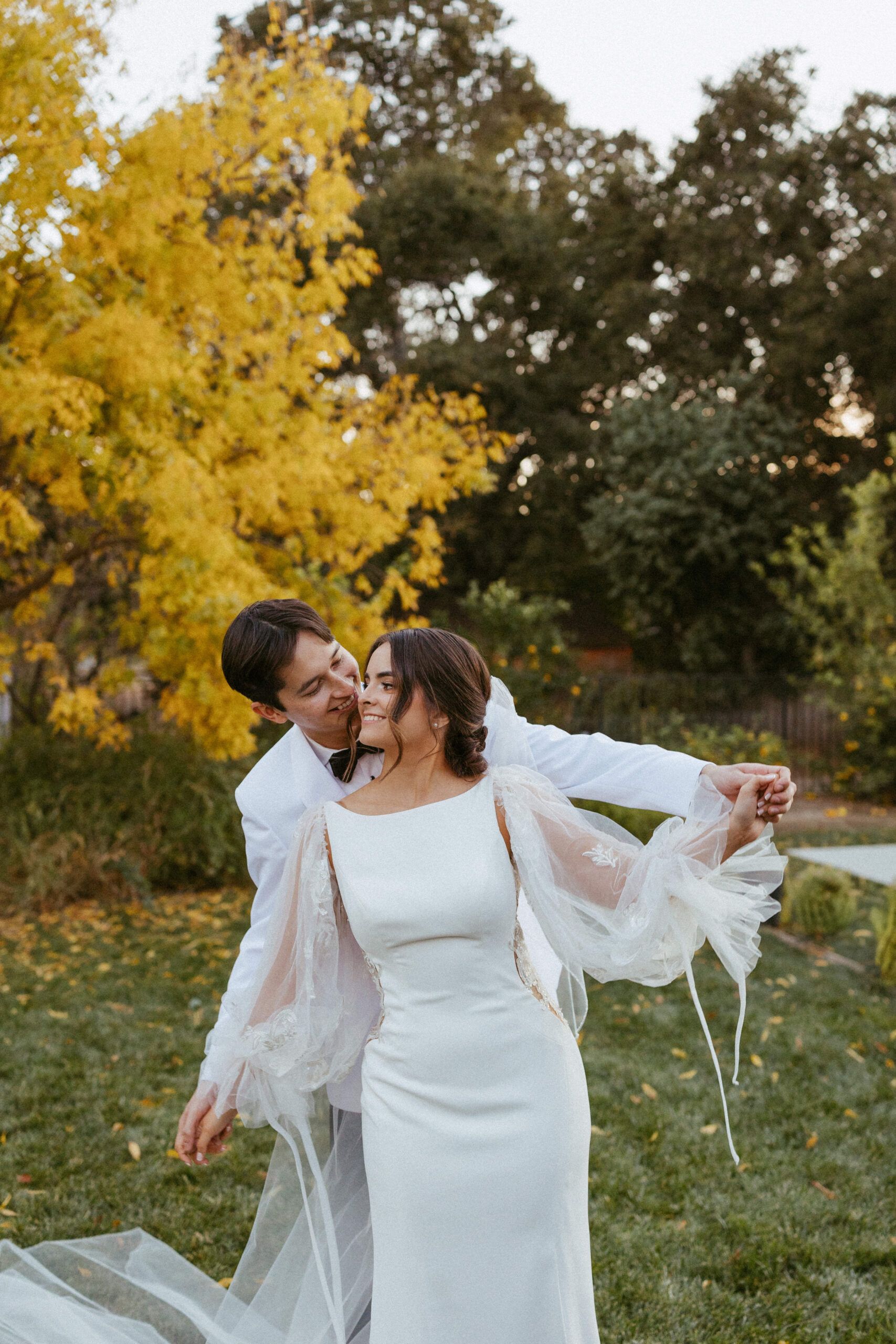 Bride and groom in all-white attire during backyard wedding in Santa Clarita
